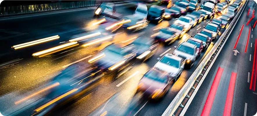 Traffic moving at speed on a multi-lane carriageway at dusk